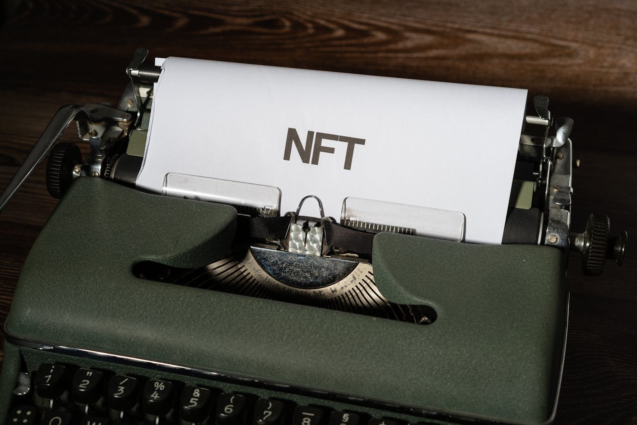 typewriter with white paper and the word "NFT" written on it